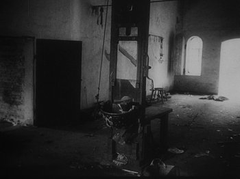 Movie still from “Ivan's Childhood” (1962), directed by Eduard Abalov – An image of a guillotine in an abandoned building; Wide shot, Low angle