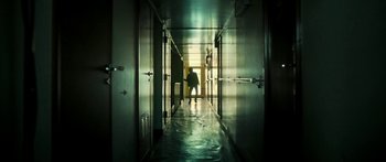 A person walking down a hallway in a building