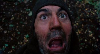 Movie still from “Jabberwocky” (1977), directed by Terry Gilliam – A person wearing a hooded jacket; Extreme Close Up shot, Overhead angle