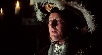 Movie still from “Jabberwocky” (1977), directed by Terry Gilliam – A person wearing a hat; Close Up shot, Low angle