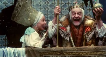 Movie still from “Jabberwocky” (1977), directed by Terry Gilliam – A couple of people that are in some kind of costume; Medium shot, Low angle