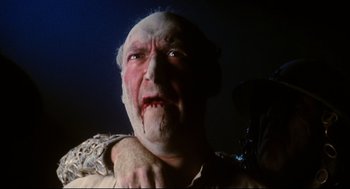 Movie still from “Jabberwocky” (1977), directed by Terry Gilliam – An old man with white skin and a beard; Close Up shot, Low angle