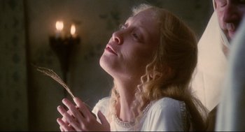 Movie still from “Jabberwocky” (1977), directed by Terry Gilliam – A woman in a white dress is holding a spoon; Close Up shot, Low angle