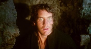 Movie still from “Jabberwocky” (1977), directed by Terry Gilliam – A person looking at the camera; Close Up shot, Low angle