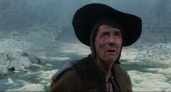 Movie still from “Jabberwocky” (1977), directed by Terry Gilliam – A person wearing a hat; Close Up shot, Low angle