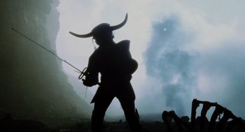 Movie still from “Jabberwocky” (1977), directed by Terry Gilliam – A man with a hat and a sword in his hand; Wide shot, Low angle