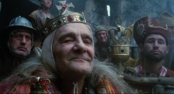 Movie still from “Jabberwocky” (1977), directed by Terry Gilliam – An old man wearing a crown and a beard; Close Up shot, Low angle