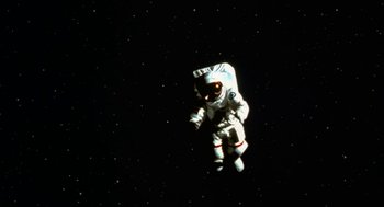 Movie still from “Jackass: The Movie” (2002), directed by Jeff Tremaine – An image of an astronaut floating in the sky; Wide shot, Overhead angle