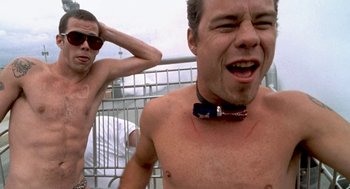 Movie still from “Jackass: The Movie” (2002), directed by Jeff Tremaine – A man with no shirt and no shirt on; Medium shot, Low angle