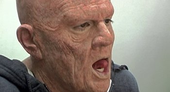 Movie still from “Jackass: The Movie” (2002), directed by Jeff Tremaine – An old man with a face like a person; Extreme Close Up shot, High angle