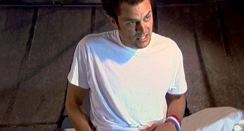 Movie still from “Jackass: The Movie” (2002), directed by Jeff Tremaine – A person wearing a white t - shirt; Medium shot, High angle