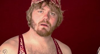 Movie still from “Jackass: The Movie” (2002), directed by Jeff Tremaine – A person with a beard wearing a hat; Close Up shot, Low angle