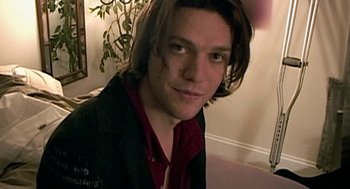 Movie still from “Jackass: The Movie” (2002), directed by Jeff Tremaine – A person with long hair; Close Up shot, High angle