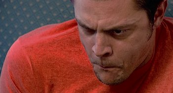 Movie still from “Jackass: The Movie” (2002), directed by Jeff Tremaine – A person wearing a red shirt; Extreme Close Up shot, Low angle