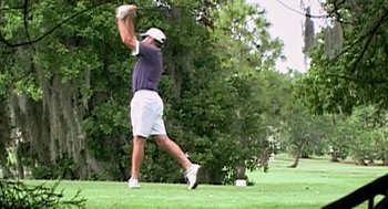 Movie still from “Jackass: The Movie” (2002), directed by Jeff Tremaine – A man swinging a golf club on a golf course; Wide shot, Low angle