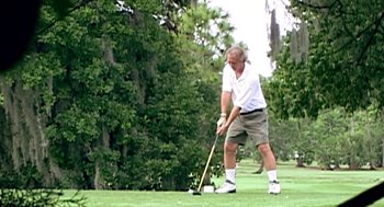Movie still from “Jackass: The Movie” (2002), directed by Jeff Tremaine – An older man is playing golf on a green; Medium shot, Low angle