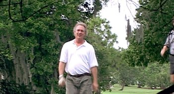 Movie still from “Jackass: The Movie” (2002), directed by Jeff Tremaine – A man in a white shirt is holding a baseball glove; Medium shot, Low angle