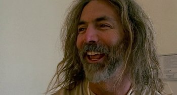 Movie still from “Jackass: The Movie” (2002), directed by Jeff Tremaine – A person with long hair; Close Up shot, Low angle