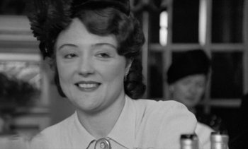 Movie still from “Jacquot of Nantes” (1991), directed by Agnès Varda – An old photo of a woman smiling at the camera; Close Up shot, Over the shoulder angle
