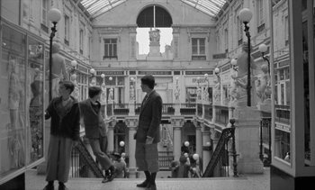 Movie still from “Jacquot of Nantes” (1991), directed by Agnès Varda – A group of people walking down a flight of stairs; Wide shot, Low angle