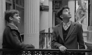 Movie still from “Jacquot of Nantes” (1991), directed by Agnès Varda – A man and a woman are looking up at the sky; Medium shot, Low angle