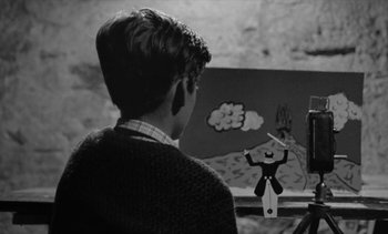 Movie still from “Jacquot of Nantes” (1991), directed by Agnès Varda – Black and white photograph of a young boy painting; Medium shot, Low angle
