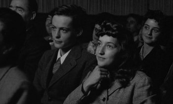 Movie still from “Jacquot of Nantes” (1991), directed by Agnès Varda – A man and a woman sitting next to each other; Close Up shot, High angle