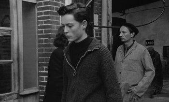 Movie still from “Jacquot of Nantes” (1991), directed by Agnès Varda – A man and a woman standing next to each other; Medium shot, Over the shoulder angle