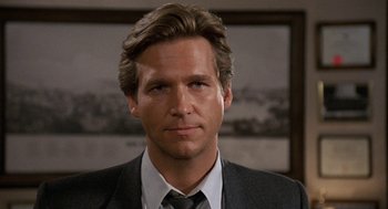 Movie still from “Jagged Edge” (1985), directed by Richard Marquand – A person wearing a suit and tie; Close Up shot, Low angle