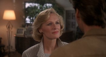 Movie still from “Jagged Edge” (1985), directed by Richard Marquand – A person wearing a sweater; Close Up shot, Over the shoulder angle