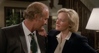 Movie still from “Jagged Edge” (1985), directed by Richard Marquand – A man and a woman standing next to each other; Close Up shot, Over the shoulder angle