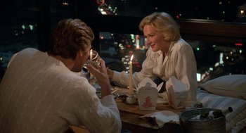 Movie still from “Jagged Edge” (1985), directed by Richard Marquand – A man and a woman sitting at a dinner table; Medium shot, Over the shoulder angle