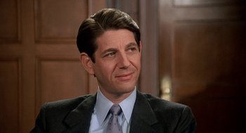 Movie still from “Jagged Edge” (1985), directed by Richard Marquand – A person wearing a suit and tie; Close Up shot, High angle