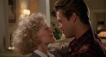 Movie still from “Jagged Edge” (1985), directed by Richard Marquand – A man and a woman looking into each others eyes; Close Up shot, Low angle