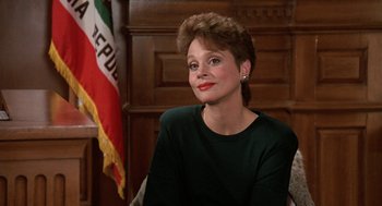 Movie still from “Jagged Edge” (1985), directed by Richard Marquand – A person sitting in a chair; Close Up shot, Low angle