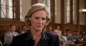 Movie still from “Jagged Edge” (1985), directed by Richard Marquand – A person wearing a suit and tie; Close Up shot, Low angle