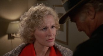 Movie still from “Jagged Edge” (1985), directed by Richard Marquand – A person wearing a hat and a jacket; Close Up shot, Over the shoulder angle