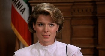 Movie still from “Jagged Edge” (1985), directed by Richard Marquand – A person wearing a white shirt; Close Up shot, Over the shoulder angle