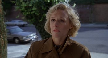 Movie still from “Jagged Edge” (1985), directed by Richard Marquand – A woman with blonde hair wearing a brown jacket; Close Up shot, Low angle