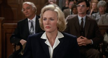 Movie still from “Jagged Edge” (1985), directed by Richard Marquand – A woman in a suit and a tie; Close Up shot, Over the shoulder angle