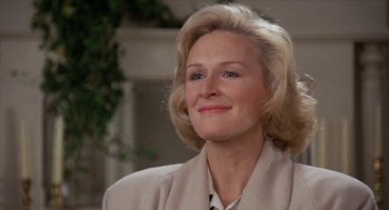 Movie still from “Jagged Edge” (1985), directed by Richard Marquand – An older woman with blonde hair wearing a beige jacket; Close Up shot, Low angle