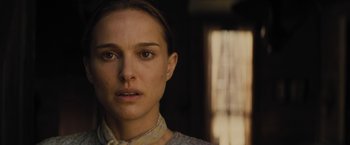 Movie still from “Jane Got a Gun” (2015), directed by Gavin O'Connor – A person wearing a dress; Close Up shot, Over the shoulder angle