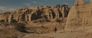 Movie still from “Jane Got a Gun” (2015), directed by Gavin O'Connor – A man riding a horse in the middle of the desert; Extreme Wide shot, High angle