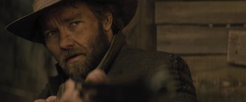 Movie still from “Jane Got a Gun” (2015), directed by Gavin O'Connor – A person holding a gun; Close Up shot, Over the shoulder angle