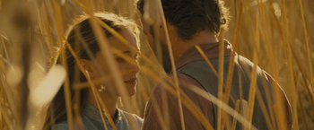 Movie still from “Jane Got a Gun” (2015), directed by Gavin O'Connor – Two people standing in tall grass looking at each other; Close Up shot, Over the shoulder angle