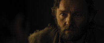 Movie still from “Jane Got a Gun” (2015), directed by Gavin O'Connor – A person with a beard looking at the camera; Close Up shot, Low angle