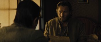 Movie still from “Jane Got a Gun” (2015), directed by Gavin O'Connor – A man looking at himself in the mirror; Close Up shot, Over the shoulder angle