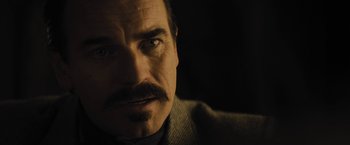 Movie still from “Jane Got a Gun” (2015), directed by Gavin O'Connor – A person with a mustache; Close Up shot, Over the shoulder angle