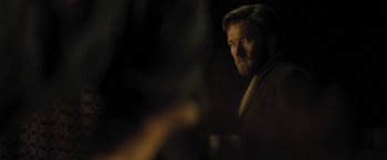 Movie still from “Jane Got a Gun” (2015), directed by Gavin O'Connor – A person in a dark room; Close Up shot, Over the shoulder angle