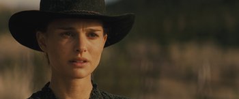 Movie still from “Jane Got a Gun” (2015), directed by Gavin O'Connor – A person wearing a cowboy hat; Close Up shot, Over the shoulder angle